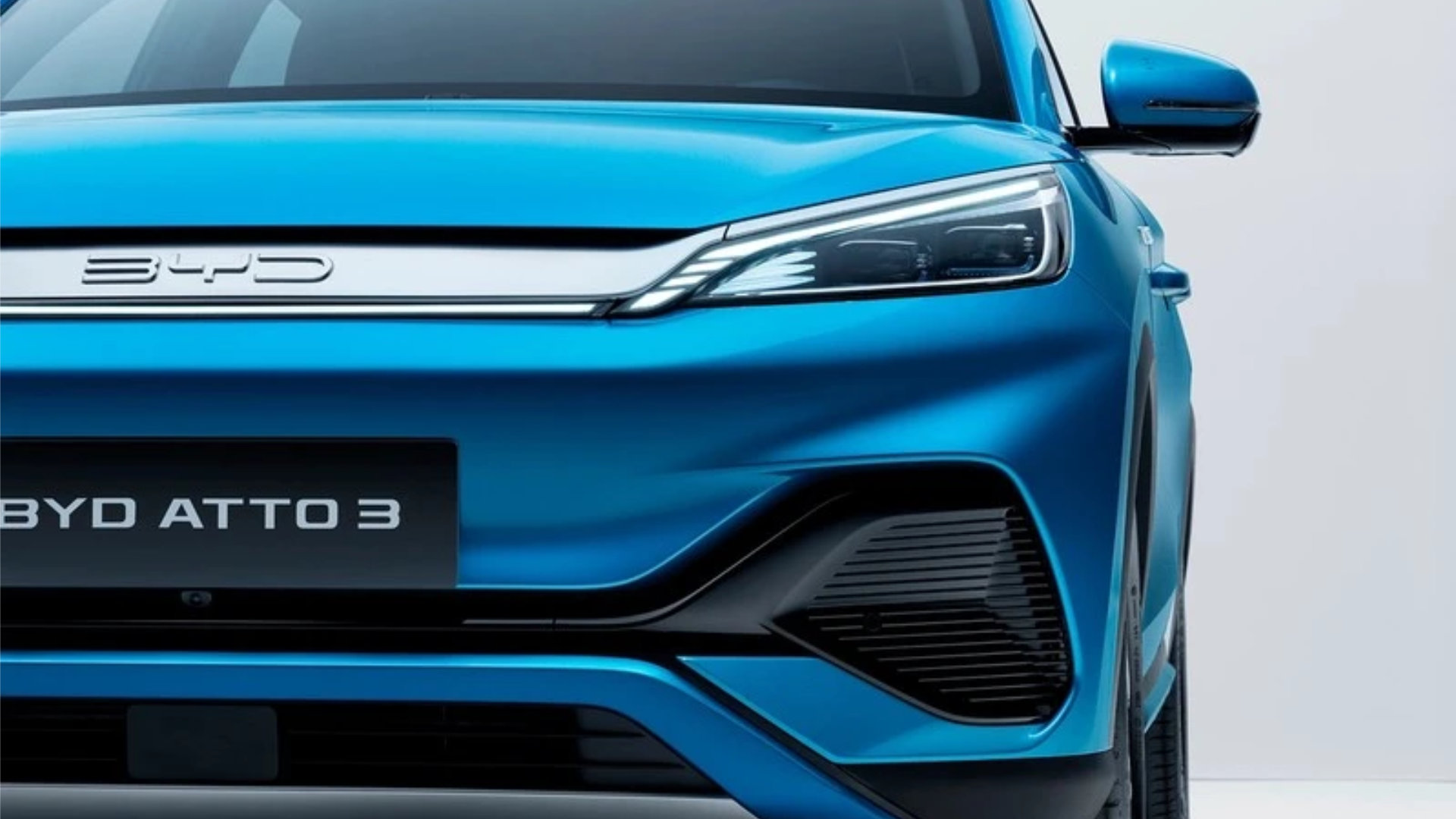 BYD Atto 3 i blå farge sett rett forfra, med skarpe LED‑lykter og BYD‑logo i grillen.