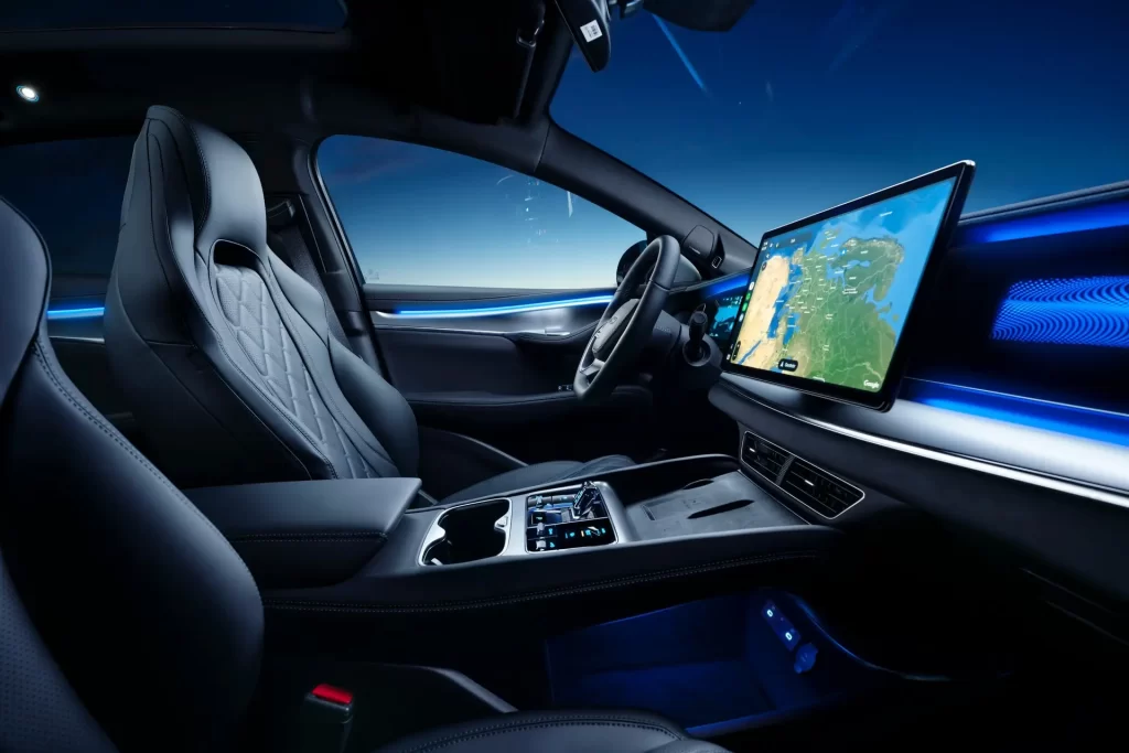 Førermiljø i Sealion 7 4x4 med digitalt instrumentpanel, stor kartskjerm og blå ambientbelysning.